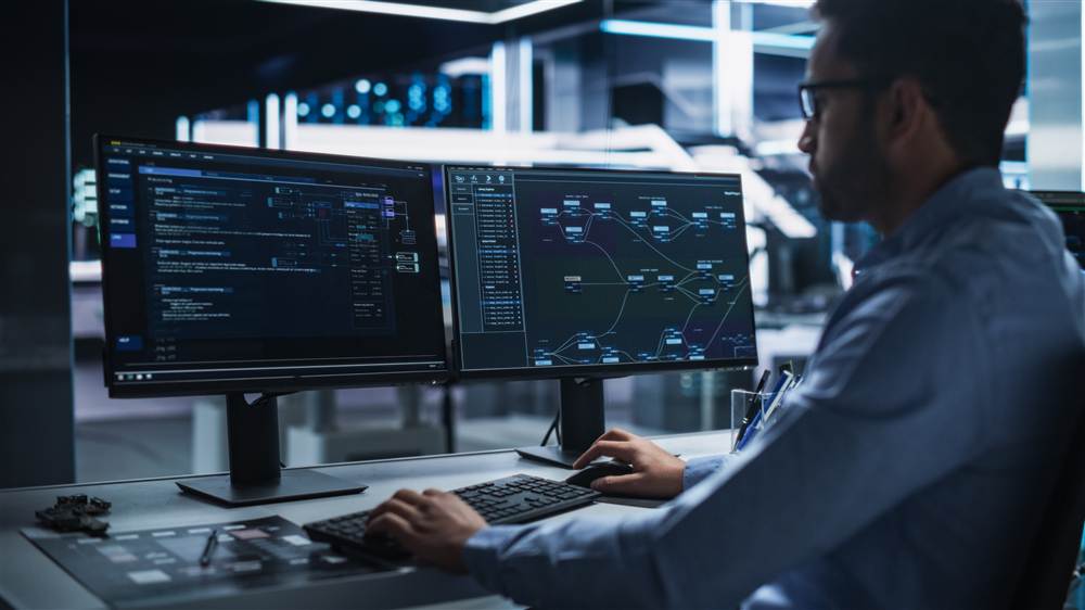 Security analyst reviewing threat data across dual monitors