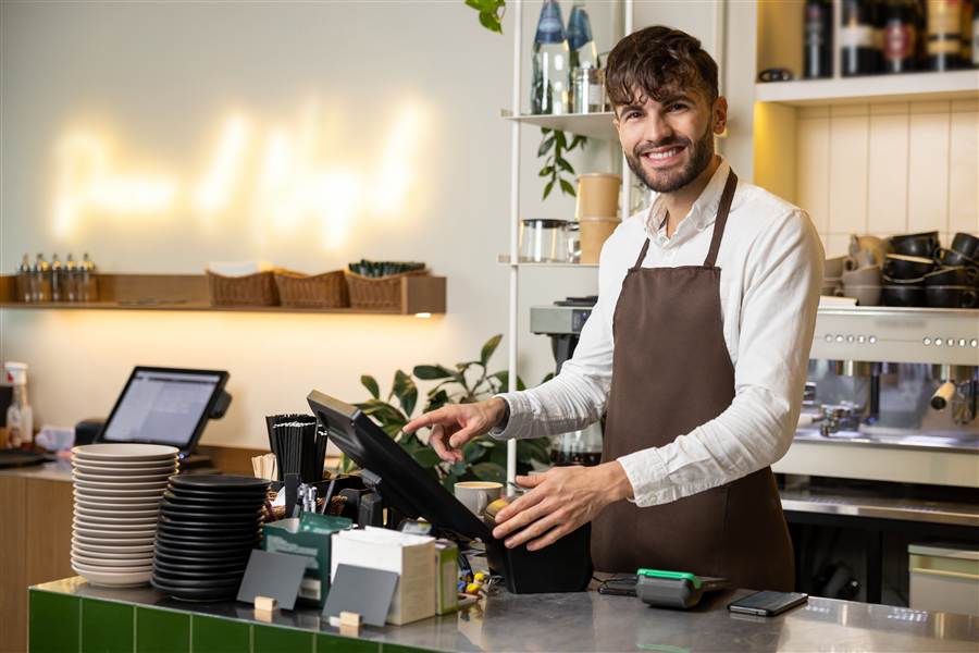 Restaurant staff member using a point of sale touchscreen terminal