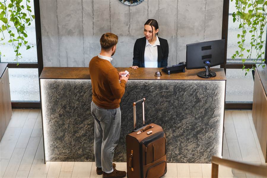 Hotel guest checking in at the front desk