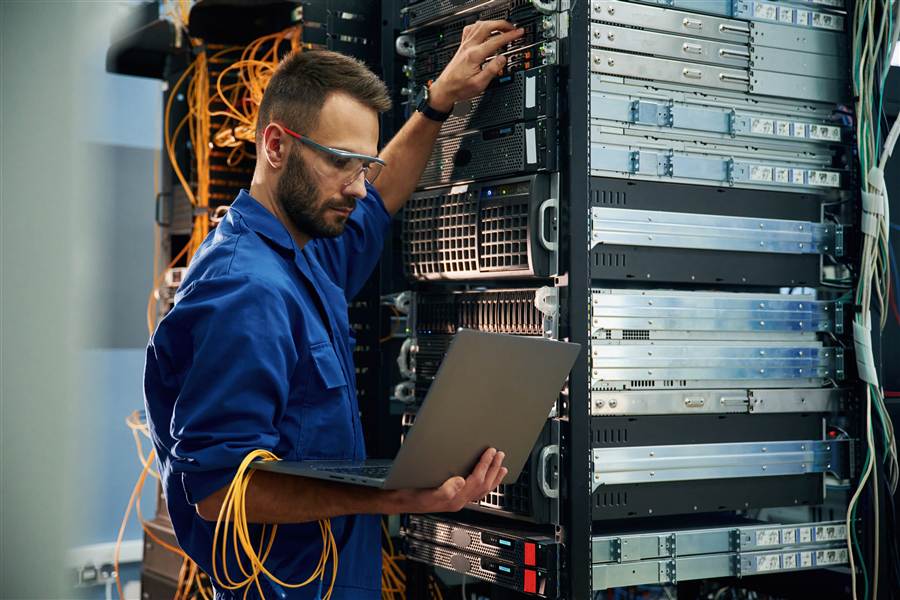 Technician managing hotel network infrastructure