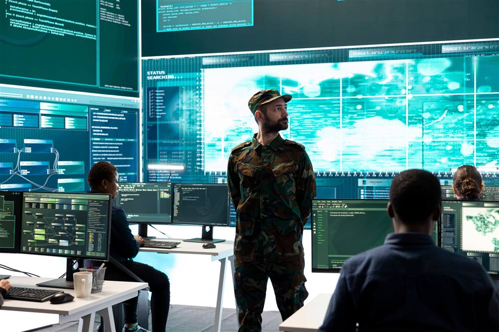 24/7 security operations team monitoring a large threat map display